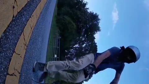 Guy Falls off Bike on Asphalt Attempting a Wheelie