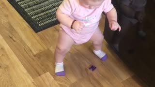 Baby learns to stand up on her own several times