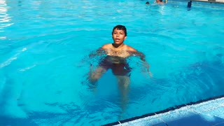 Boy Learns How To Swim In Pool