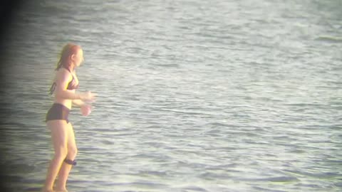 Girl on wake board in black bathing suit almost falls