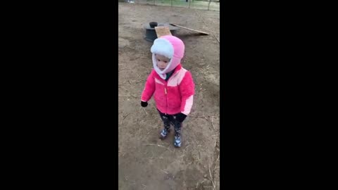 Cute toddler holding a baby goat.