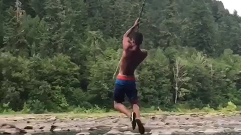 Rope swing fail guy spins flips and lands on back water lake