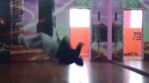 Guy break dances and slams the floor hard