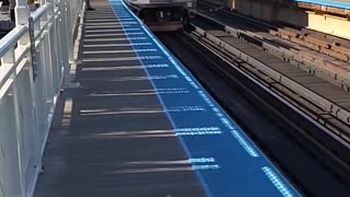 A Blueline Train Slowly Pulls Into The Station