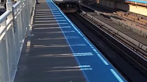 A Blueline Train Slowly Pulls Into The Station