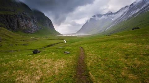 Foundational shot of the valley leading to the same horse beach in Lofoten, Norway