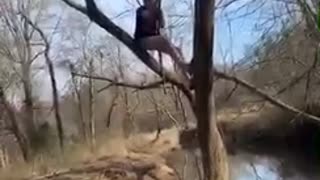 Guy tries to swing on vine over a river, vine breaks and guy falls into water