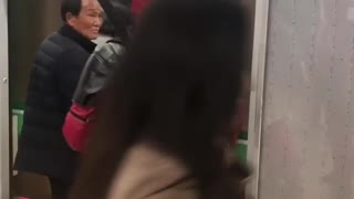 Man in red deadpool costume on nyc train