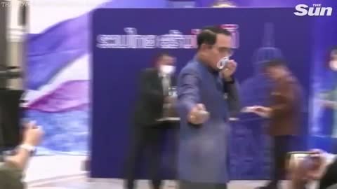 Thailand prime minister spraying his people with hand gel