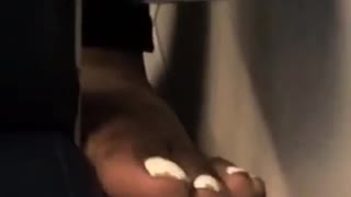 White toe nails feet between subway seat