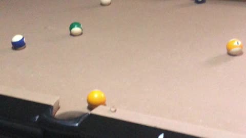 My five year old daughter playing pool