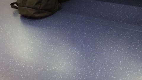 Man on train cleaning feet with red towel