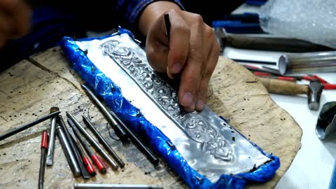 Craftsman Using Tool Carving Thai Pattern On Metal Plate