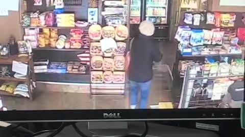 Security camera, woman walks inside convenience store, trips on floor and falls