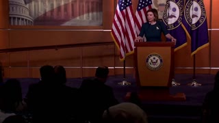 Pelosi slowly walks away from the podium as reporters ask her questions