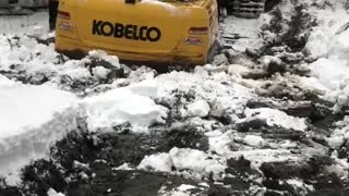 Excavator in deep rescuing a Groomer!