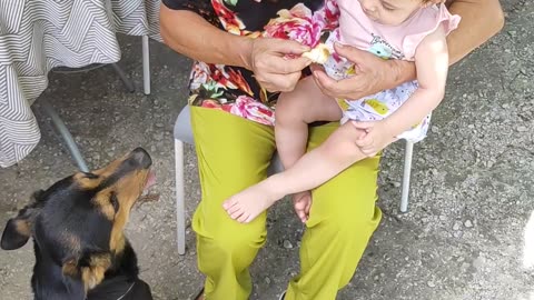 Family Tenderness: A woman nursing a dog and a baby