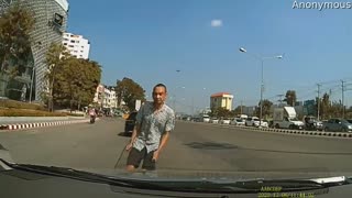 Driver Avoids Peculiar Man in Traffic