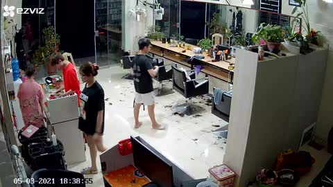 Guy and Gal Tumble over Barbershop Cabinet