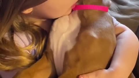 Little Girl Holds Her Best Puppy Pal