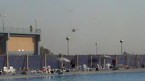 Two MH-53M helicopters flyover pool