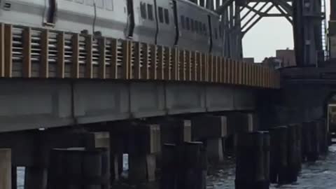 crazy video guy jumps off of moving train into ocean