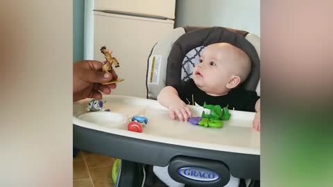 Cute baby playing toys, adults playing.