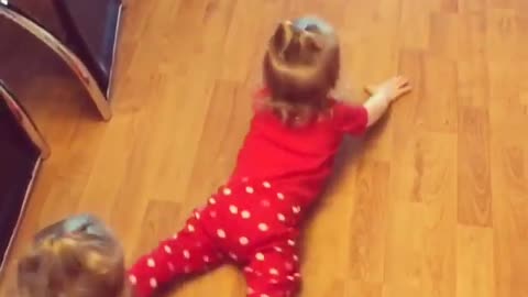 Twin baby girls mop the floors by crawling backwards