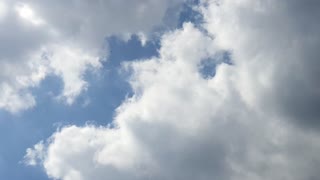 Glorious clouds bathing in sunny sky