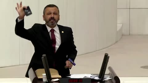 Turkish lawmaker smashes phone with hammer in parliament to protest social media bill