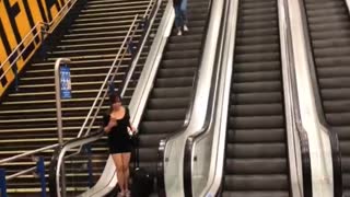 Suitcase Slides Down Escalator