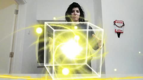 Edited video graphics girl holds levitating yellow cube