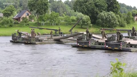 Troops build poonton bridge to move tanks accross river during Nato Drills in Lithuania