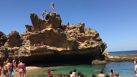 Couple misjudge cliff jump into rock pool