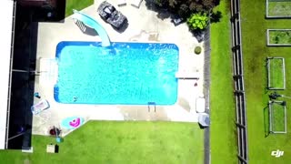 Man in Birthday Suit Jumps into Swimming Pool on a Sunny Day