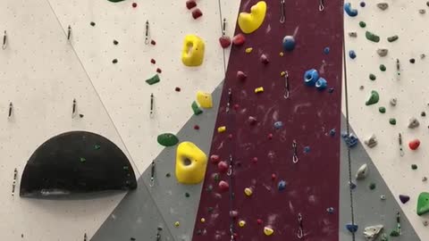 Guy rock climbs to the top of wall, falls and belays girl below