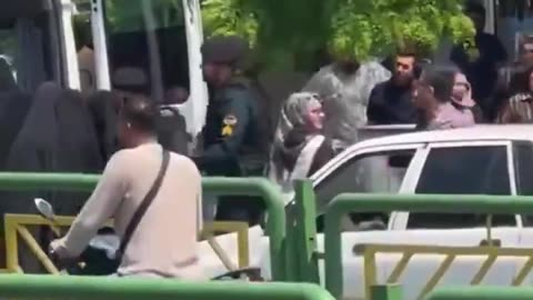 Iranian police drag woman into the back of a police vehicle simply because she