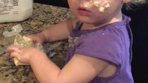 Young Girl Slathers Butter All Over Her Face