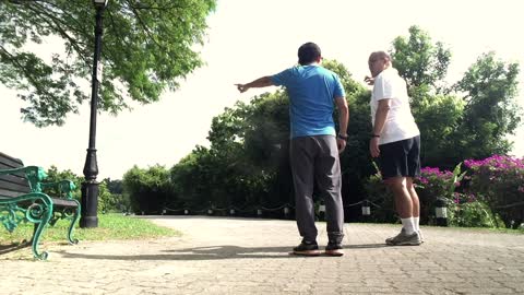 Short clip of 2 men jogging at a park