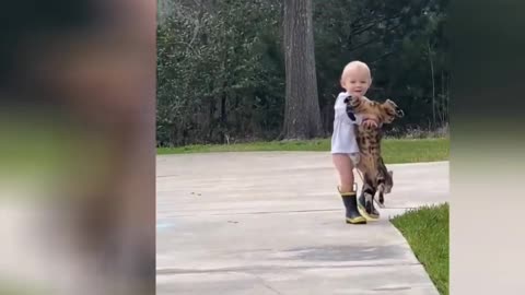 A Baby holding his cat