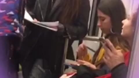 Girl yellow jacket eating pasta out of tupperware on subway