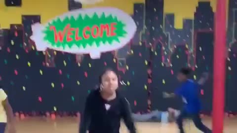 Tall man rollerskating, falls down on his butt and stays down, friend laughs at him