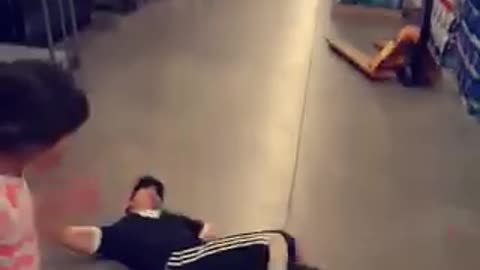 Guy black clothes high kick fail falls on floor girl pink
