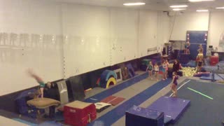 Gymnastics girl in white shirt misses red jumping block face plant