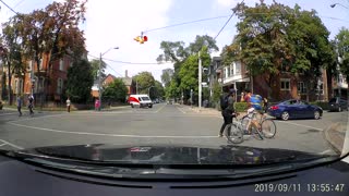 Cyclists Struggle at Stop Sign