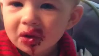 Baby's sour face reaction to blueberries