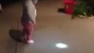 Tot Girl Tries To Chase Light From Flashlight Attached To Her Head