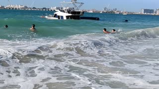 Onlookers Watch as Boat Sinks off the Coast of Dubai