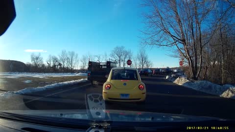 A guy uses the shoulder to cut off people waiting to get on the highway