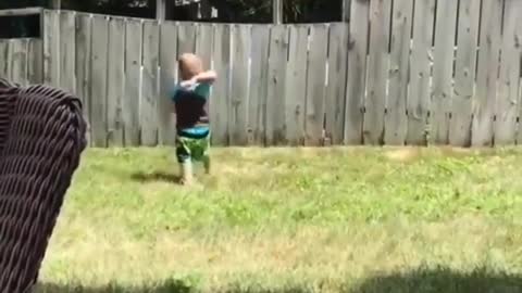 A Small Boy Playing Catch with his Neighbour's Dog